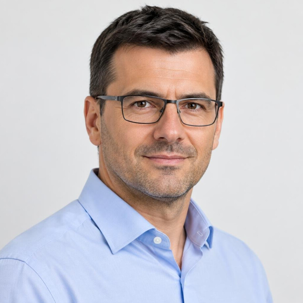 Studio portrait of a Croatian man with glasses in a shirt